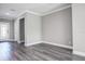 This home features a welcoming entryway with modern gray walls and luxury vinyl plank flooring at 10517 Crestview Heights Ave, Thonotosassa, FL 33592