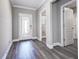 Bright foyer featuring wood flooring and a decorative front door at 10517 Crestview Heights Ave, Thonotosassa, FL 33592
