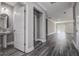 Hallway boasts wood floors, neutral walls, and open access to living areas at 10517 Crestview Heights Ave, Thonotosassa, FL 33592
