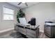 Well-lit home office with wood-look floors, a modern desk, and ample workspace at 10517 Crestview Heights Ave, Thonotosassa, FL 33592