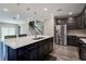 Kitchen features an eat-in island, pendant lighting, stainless appliances and dark wood cabinets at 10517 Crestview Heights Ave, Thonotosassa, FL 33592