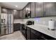 This kitchen features stainless appliances and granite countertops with dark wood cabinets at 10517 Crestview Heights Ave, Thonotosassa, FL 33592