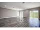 Bright living room with wood floors, recessed lighting and sliding glass doors at 10517 Crestview Heights Ave, Thonotosassa, FL 33592