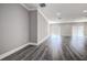 Open floor plan with wood flooring and plenty of natural light at 10517 Crestview Heights Ave, Thonotosassa, FL 33592
