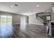 Spacious living area with wood floors, neutral walls, and sliding glass doors at 10517 Crestview Heights Ave, Thonotosassa, FL 33592