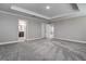 Spacious main bedroom with a tray ceiling, neutral paint, carpet, and two entry doors at 10517 Crestview Heights Ave, Thonotosassa, FL 33592