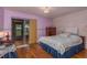 Comfortable bedroom features hardwood floors, stylish furnishings, and access to screened porch at 1065 Tartan Dr # C, Palm Harbor, FL 34684