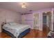 Inviting bedroom with hardwood flooring, barn door and ensuite bathroom at 1065 Tartan Dr # C, Palm Harbor, FL 34684