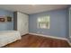 Bright bedroom with wood floors, built-in closet, and a view of the backyard at 1065 Tartan Dr # C, Palm Harbor, FL 34684