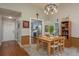 Dining area with a view into the kitchen featuring gray cabinets and modern appliances at 1065 Tartan Dr # C, Palm Harbor, FL 34684