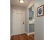 Welcoming entryway with hardwood floors leading to kitchen with gray cabinets at 1065 Tartan Dr # C, Palm Harbor, FL 34684