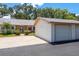 View of home's front exterior featuring a garage, landscaped yard, and driveway at 1065 Tartan Dr # C, Palm Harbor, FL 34684