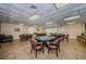 A game room featuring poker tables, leather chairs, and tile flooring, perfect for entertainment at 1065 Tartan Dr # C, Palm Harbor, FL 34684