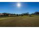 Golf course view with a clear blue sky overhead and a blue flag blowing in the wind on a sunny day at 1065 Tartan Dr # C, Palm Harbor, FL 34684