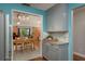 Open concept kitchen with gray cabinets and adjacent dining area with barn doors at 1065 Tartan Dr # C, Palm Harbor, FL 34684
