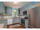 Beautiful kitchen with gray cabinets, stainless appliances, and granite countertops at 1065 Tartan Dr # C, Palm Harbor, FL 34684