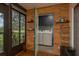 Bright laundry room with wood paneled walls, washer, dryer, and shelving for storage at 1065 Tartan Dr # C, Palm Harbor, FL 34684