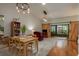 Open living and dining area featuring barn doors and a modern light fixture at 1065 Tartan Dr # C, Palm Harbor, FL 34684