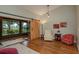 Comfortable living room featuring a barn door, arm chairs, large windows, and hardwood floors at 1065 Tartan Dr # C, Palm Harbor, FL 34684