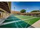 Well-maintained shuffleboard courts with covered seating areas, providing a recreational space for residents at 1065 Tartan Dr # C, Palm Harbor, FL 34684