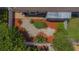 Birds eye view of backyard with mature trees, a screened in lanai, mulch, and stone pathways at 1126 Haley Ln, Dunedin, FL 34698