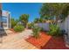 The backyard features a lush garden with stone pathways and a wooden boardwalk leading to the screened lanai at 1126 Haley Ln, Dunedin, FL 34698