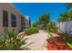 This backyard is meticulously landscaped with winding pathways and mature trees for relaxing or entertaining at 1126 Haley Ln, Dunedin, FL 34698