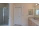 Neutral-toned bathroom features a walk-in shower, large mirror, and a vanity with great storage at 1126 Haley Ln, Dunedin, FL 34698
