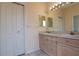 Well-lit bathroom features a double vanity with great storage and large mirror at 1126 Haley Ln, Dunedin, FL 34698