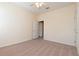 Comfortable bedroom with soft carpeting, a ceiling fan, and a convenient doorway to an additional room at 1126 Haley Ln, Dunedin, FL 34698