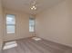 Tranquil carpeted bedroom with ample natural light streaming through two windows, creating a peaceful retreat at 1126 Haley Ln, Dunedin, FL 34698
