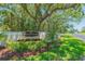Scenic view of Virginia Crossing entrance with lush greenery and manicured lawns at 1126 Haley Ln, Dunedin, FL 34698