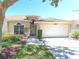 Inviting single-story home with a two-car garage, landscaped front yard and neutral color scheme at 1126 Haley Ln, Dunedin, FL 34698