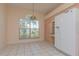 Bright kitchen featuring tile flooring, wooden cabinets, and stainless steel refrigerator at 1126 Haley Ln, Dunedin, FL 34698