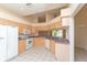 Bright kitchen featuring stainless steel appliances, tile flooring, and wood cabinetry at 1126 Haley Ln, Dunedin, FL 34698