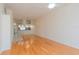 Open-concept living area showcasing wood floors and a partial view of the kitchen at 1126 Haley Ln, Dunedin, FL 34698