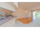 Open-concept living room with hardwood floors, high ceilings, and sliding glass doors to the outside at 1126 Haley Ln, Dunedin, FL 34698
