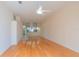 Open-concept living area showcasing wood floors and a partial view of the kitchen at 1126 Haley Ln, Dunedin, FL 34698