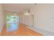 Bright living room featuring hardwood floors, natural lighting and a decorative chandelier at 1126 Haley Ln, Dunedin, FL 34698