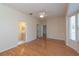 Spacious main bedroom with hardwood floors, a ceiling fan, and an attached bathroom for added convenience at 1126 Haley Ln, Dunedin, FL 34698