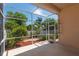 This screened-in patio offers a relaxing view of the well-manicured landscaping in the backyard at 1126 Haley Ln, Dunedin, FL 34698