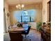Dining room with an oval table, four chairs, buffet, chandelier, and a large window with sheer curtains at 11430 Nature Trl, Port Richey, FL 34668