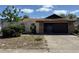 Home exterior showing stonework and arched gate with attached two car garage at 11430 Nature Trl, Port Richey, FL 34668