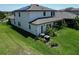 Two-story home featuring a spacious backyard with well-maintained landscaping and a screened-in porch at 13103 Monach Isles Dr, Riverview, FL 33579