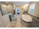 Bathroom featuring a soaking tub, walk-in shower, dual vanity, and marble flooring at 13103 Monach Isles Dr, Riverview, FL 33579
