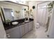 Bathroom features a granite countertop, a large mirror, and tiled floors at 13103 Monach Isles Dr, Riverview, FL 33579