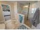 Modern bathroom featuring marble floors and a glass-enclosed shower with pebble flooring at 13103 Monach Isles Dr, Riverview, FL 33579