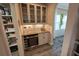 Functional butler's pantry with a wine cooler and stylish bar, plus ample storage and lighting at 13103 Monach Isles Dr, Riverview, FL 33579