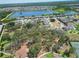 Aerial view of the community showcasing the lake, tree-lined streets, and well-maintained homes at 13103 Monach Isles Dr, Riverview, FL 33579