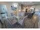 Open-concept dining room showcasing modern chandelier and connection to kitchen with island seating at 13103 Monach Isles Dr, Riverview, FL 33579